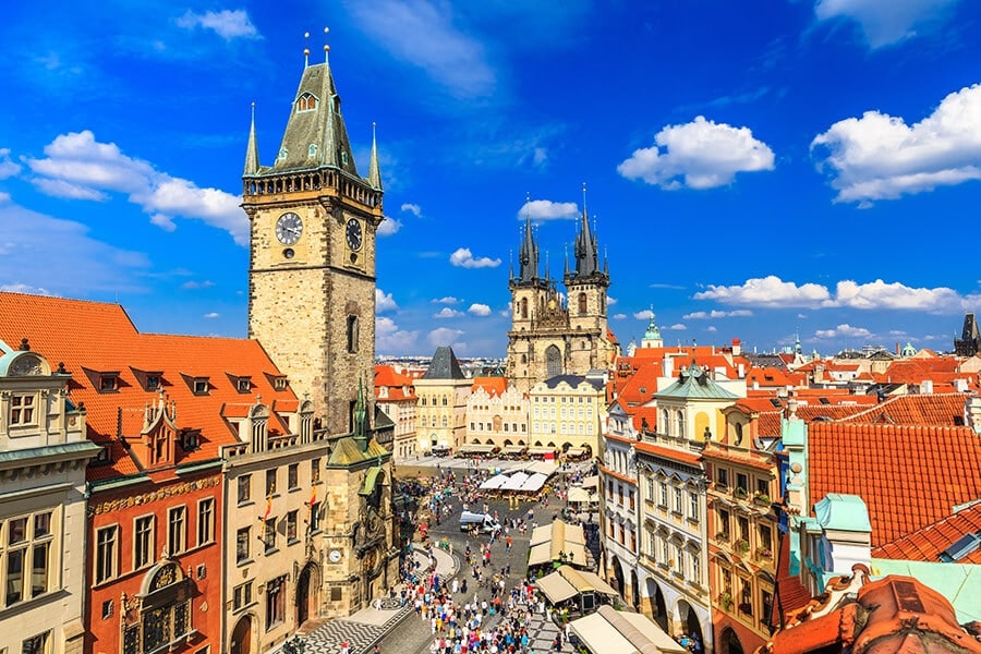 How to get a residence permit, permanent residence and citizenship of the Czech Republic. View of Tyn Church and Town Hall on Old Town Square in Prague